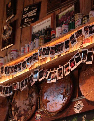 Polaroid photos of Notch Club members strung on the wall of Jack Brown's Beer and Burger Joint, Harrisonburg, VA.